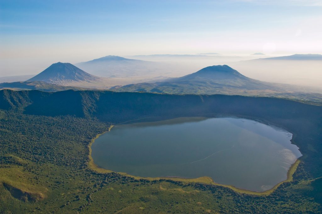 Empakai crater and lake, in the background Ol Doinyo Lengai (left) and Keremasi (right), aerial view, Tanzania